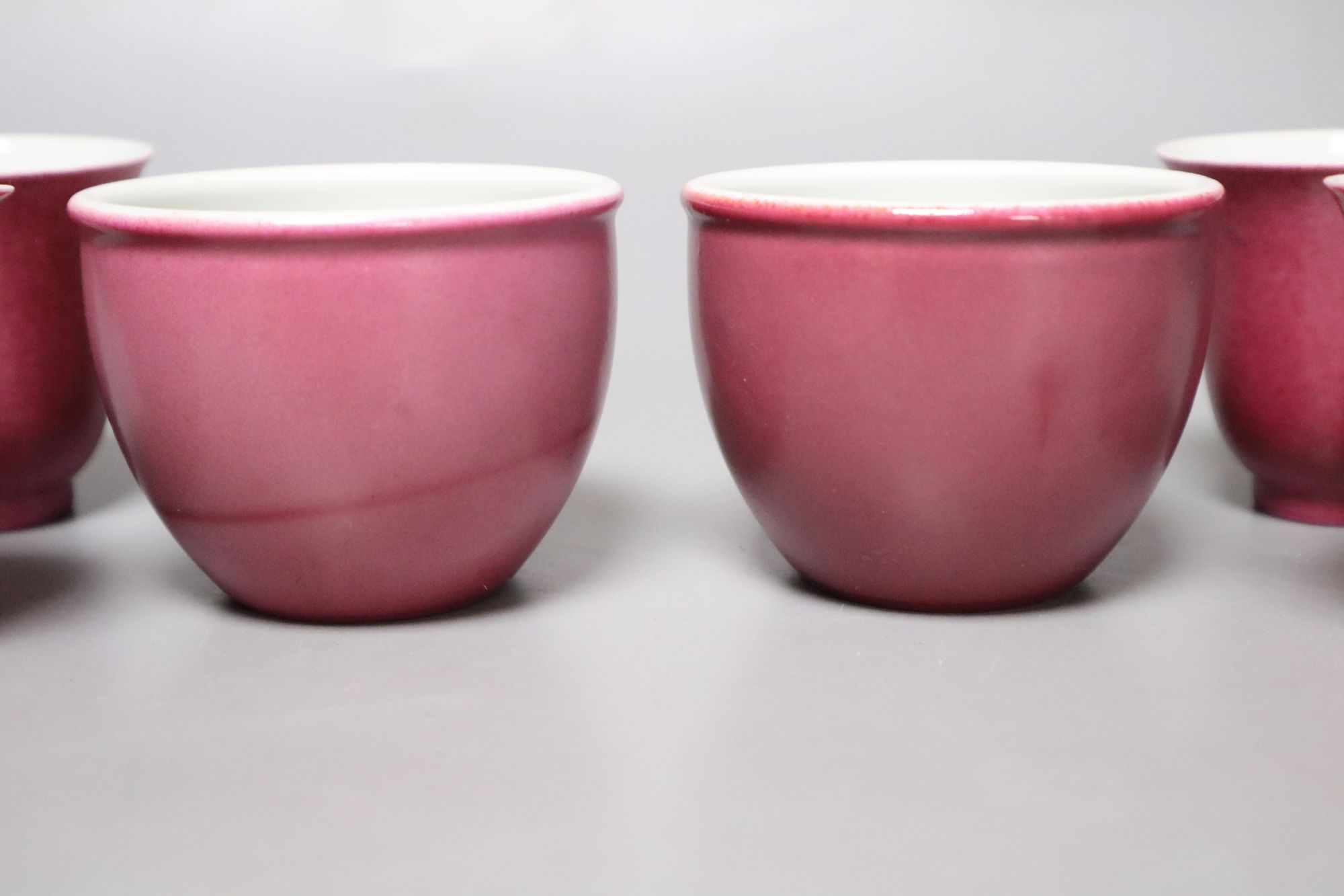 Four Chinese ruby ground tea cups and a pair of similar pots, height 6cm